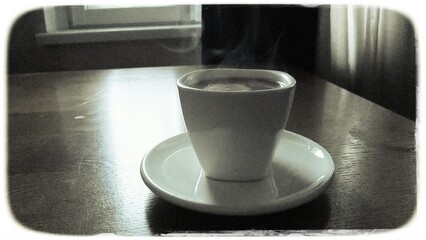 Hot coffee cup on a saucer on a wooden table near a window, with rising steam and vintage retro film style