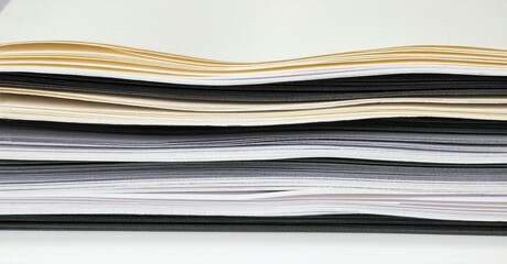 Layered papers exhibit varying shades, creating wavy texture. Minimalist composition focuses on monochrome tones, simple design.