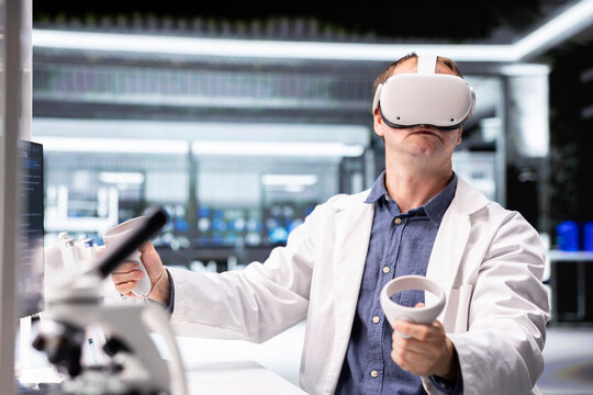Male chemist using VR glasses in research lab for molecular biology experiment. Virtual reality transforms biotechnology and genetics research in modern interactive laboratory tasks. - Powered by Adobe
