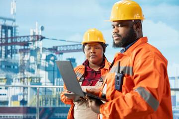 Team of environmental officers working together to inspect offshore platform gear for pollution. Drilling rig coworkers evaluate spill prevention systems to reduce ocean contamination