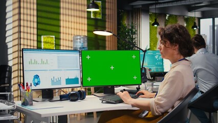 Executive assistant analyzing KPI metrics on computer monitor with mockup, handling task completion...