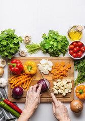 Hands Chopping Vegetables On Cutting Board