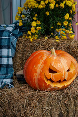 orange Halloween pumpkin on a haystack