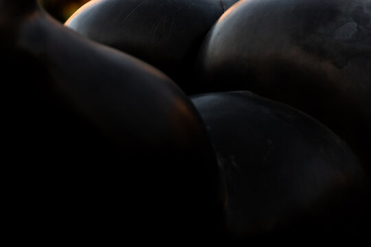 View of dark, smooth, spherical shapes clustered together, creating an abstract visual texture with soft lighting and deep shadows, Yerevan, Yerevan, Armenia.