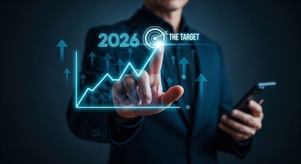 "A businessman in a dark suit touching a glowing point on a futuristic line graph that is trending upwards. The graph is pointing towards the goal '2026 THE TARGET' with a bullseye icon. Upward arrows