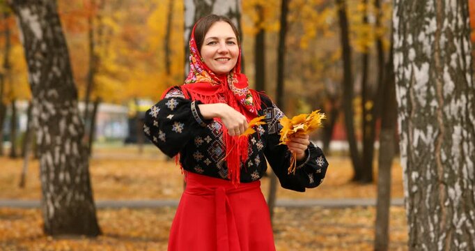Young beautiful woman in a headscarf in an autumn park