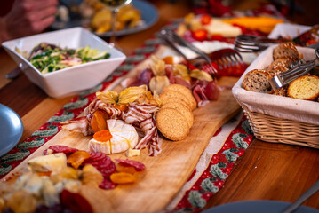 Delicious charcuterie board with cheese, crackers, and fruit on a wooden table