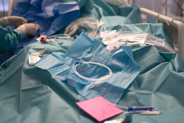 Medical staff performing procedure in sterile operating room with various surgical instruments