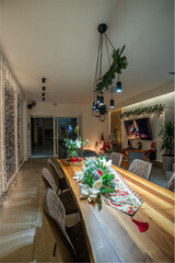 Festive dining room decorated for Christmas with a long wooden table