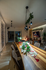 Festive dining room decorated for Christmas with a long wooden table
