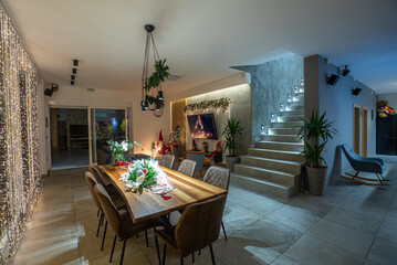 Cozy Christmas dining room with festive decorations and warm lighting