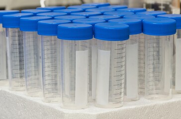 Plastic test tubes empty bottle vials milliliter measurement with caps in styrofoam tray.