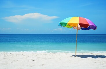 Fototapeta premium Beach umbrella, colourful, white sand, blue sea & sky