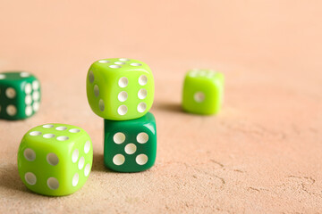 Green dices on beige background