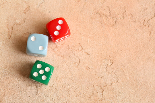 Different dices on beige background