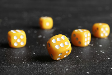 Yellow dices on dark background