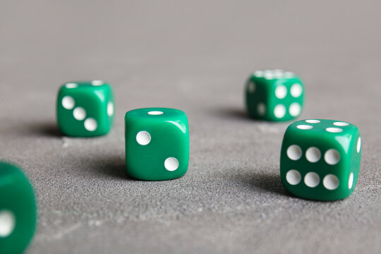 Green dices on grey background