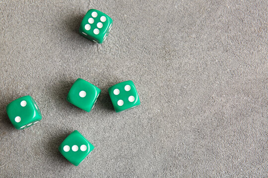 Green dices on grey background