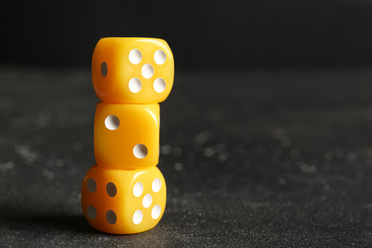 Yellow dices on dark background