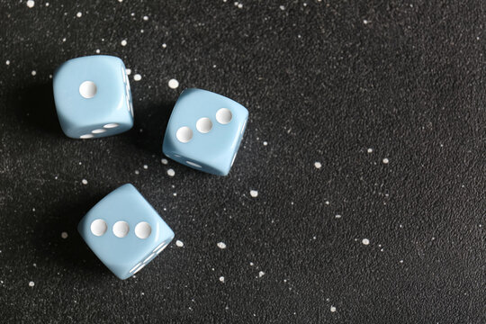 Blue dices on dark background