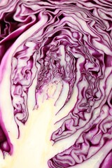 Obraz premium Cut red cabbage as background, closeup view