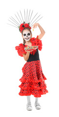 Little girl dressed for Halloween with candies on white background