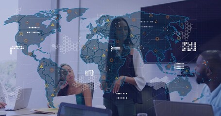 Presenting businesswoman showcasing data on holographic map in conference room, laptops visible
