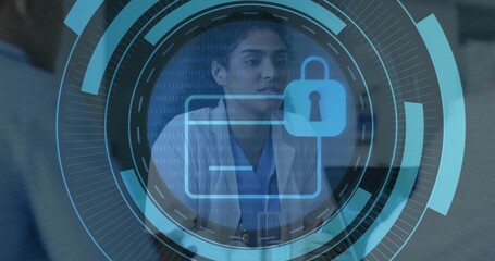 Examining female doctor studying digital interface with folder icon in exam room, with stethoscope