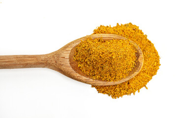 Close-up of spoon with spilled cumin on white background