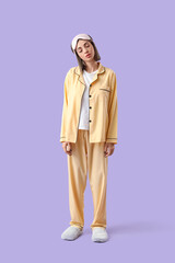 Female sleepwalker in pajamas on lilac background