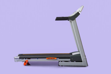Modern treadmill on lilac background