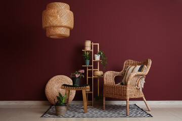 Interior of room with wicker armchair, shelf and plants