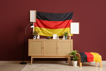 Interior of room with German flags, blank frames and commode