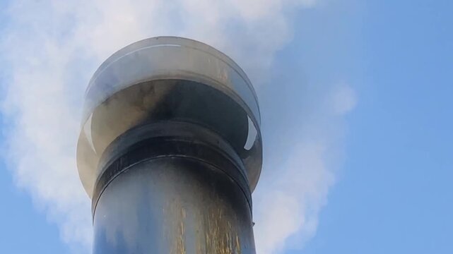 smoker, white smoke from a chimney against a blue