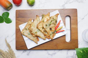 Tempe Mendoan: Traditional Indonesian Food, Fried Tempe with flour and celery pieces. Tempe Goreng or Tempe Mendoan is Indonesian traditional food made from tempeh covered in flour batter.
