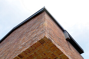 Modern Brick Building Corner with Clear Blue Sky Background