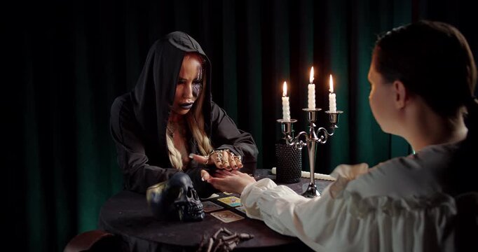 Fortune teller predicting future by candlelight