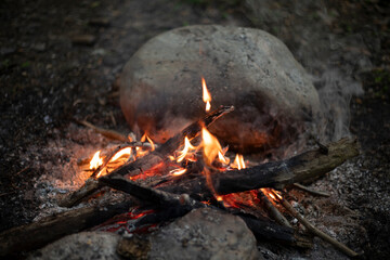 The flames of a campfire in the dark. Flames. Burning wood.