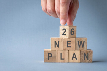 2026 New Plan, on stacked wooden blocks. New year concept.