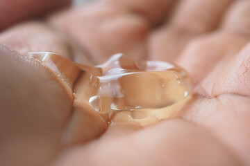 Aloe vera gel resting on a palm in natural light