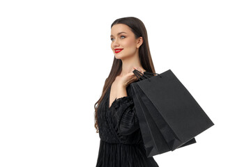 Woman smiles joyfully with black shopping bags, isolated, PNG