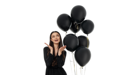 Young woman joyfully poses with black balloons, isolated, PNG