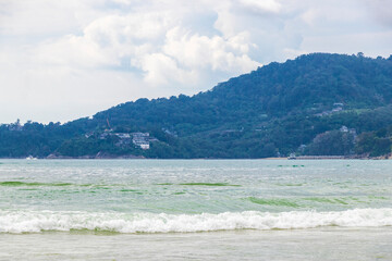 Patong Beach Phuket with turquoise blue water and mountains Thailand.