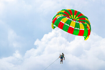 Patong Beach Phuket with parachute sport and parasailing activity Thailand.