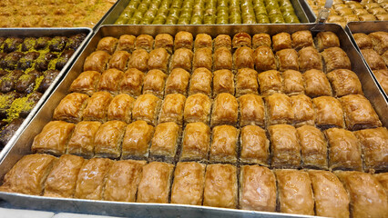 Delicious baklava neatly arranged in trays at a bakery