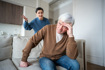 Enraged woman berates husband feel exhaustion under constant verbal assault. Angry wife, exhausted spouse, marital conflict, emotional fatigue, constant nagging, elderly couple relationship strain