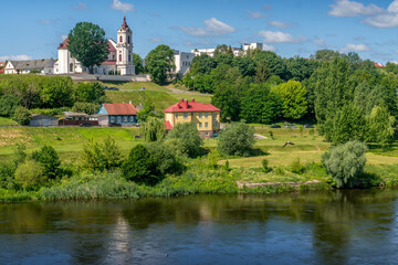 Obraz premium Neman River flowing through green hills in Hrodna, Belarus above the lush riverside landscape. 