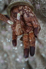 Indian bride's hands decorated with mehndi
