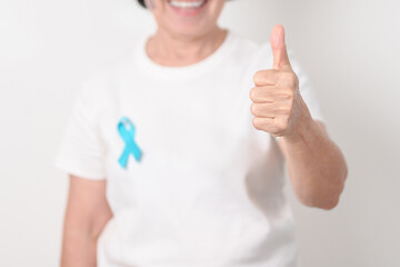 Elderly with blue Ribbon for concept of blue November, November Prostate Cancer Awareness month,...