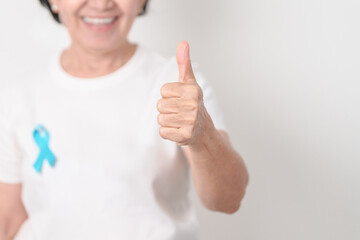 Elderly with blue Ribbon for concept of blue November, November Prostate Cancer Awareness month,...
